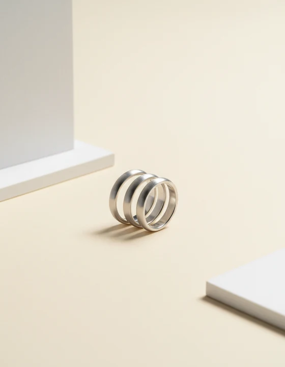 Three slim sterling silver stacking rings resting together.